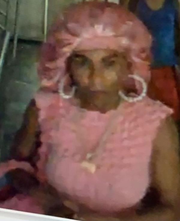 The woman suspect was wearing a pink outfit and a matching shower cap.